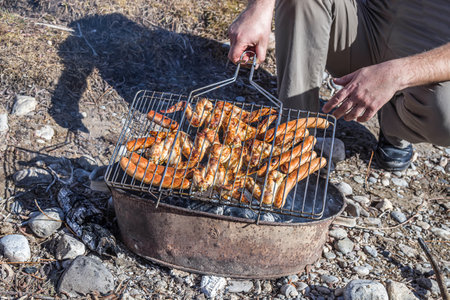 Meat is cooked on a grill in nature close-up. Picnic in nature.の写真素材