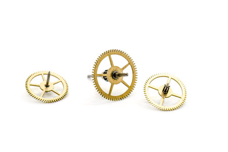 Gears from clock isolated on white background. Photo with shallow depth of field.の写真素材