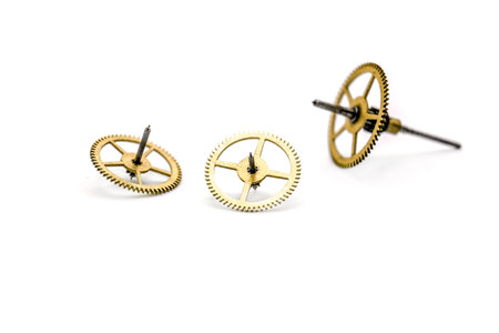 Gears from clock isolated on white background. Photo with shallow depth of field.の写真素材