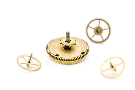 Gears from clock isolated on white background. Photo with shallow depth of field.の写真素材