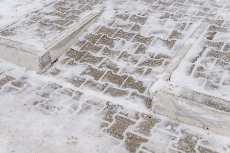 Fresh snowball on paving slabs in the parkの写真素材