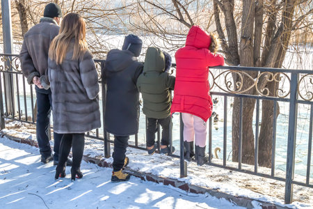 People feed birds in winter in city pond in parkの写真素材