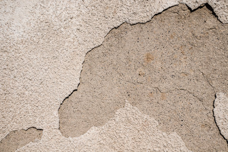 Cracked plastered cement wall as background close-upの写真素材