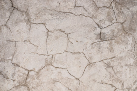 Cracked plastered cement wall as background close-upの写真素材