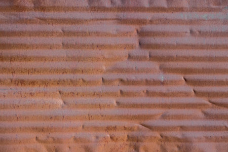 Old rusty tin plate as background close-up