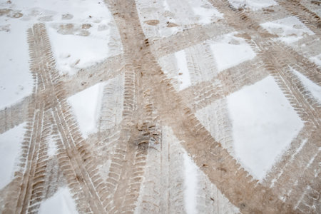 Traces of car protectors on melted snow in natureの写真素材