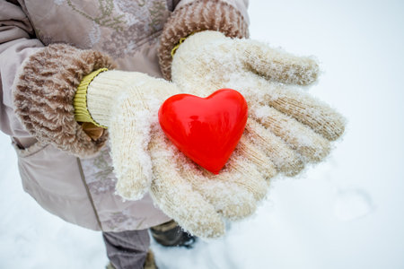 Box in the form of a heart in a hand in winter.Give a gift for Valentine's Dayの写真素材
