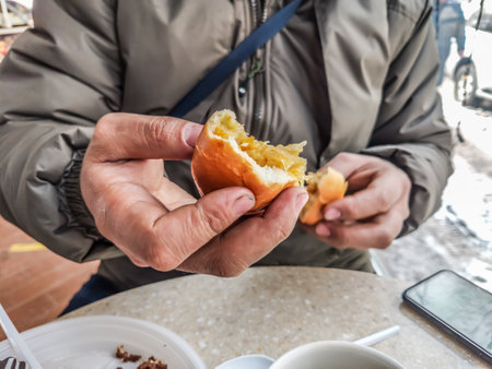 Pie with cabbage in the hand of a man in a cafeの写真素材