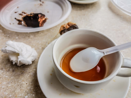 Empty cup with drunk tea on a table in a cafeの写真素材