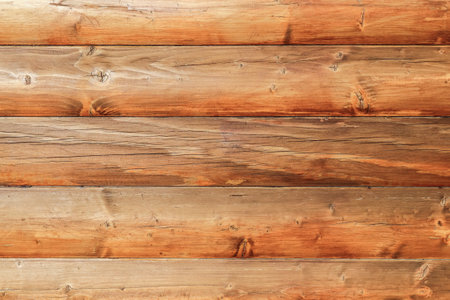 Wooden log house as a background.Wooden background from round logs with natural wood patternの写真素材