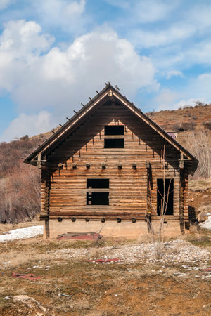 Old wooden unfinished house from logsの写真素材