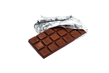 Milk chocolate with foil on a white backgroundの写真素材