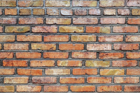Texture of an old red brick wall with groutの写真素材