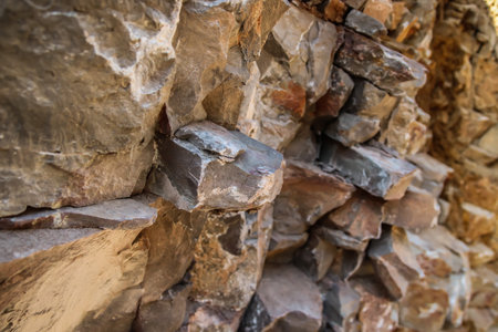 Rough stone background in a quarry closeup for texture design.Interesting background picture of a...