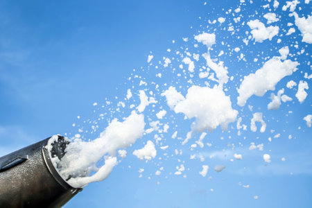 Foam party, foam cannon against the blue sky. Soap foam flies from a cannon against the sky.の写真素材