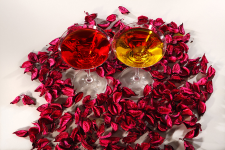 Wineglasses on rose petals backgroundの写真素材