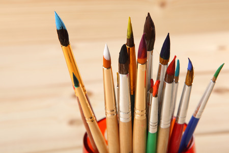 Paint brushes on wooden background. Selective focusの写真素材