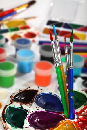 Paint palettes and brushes. Selective focusの写真素材