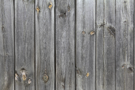 A wooden wall of old, gray boards. Retro background of textured boards for your designの写真素材