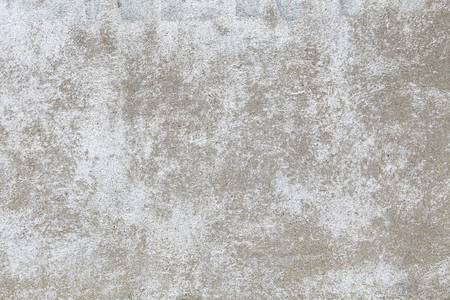 An old concrete wall, painted in white, with damaged paint. Background for your designの写真素材