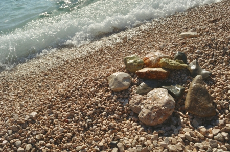 Stones on the beach with waveの写真素材