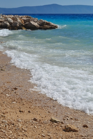 Waves on beautiful beach with sand and stones in Podgoraの写真素材