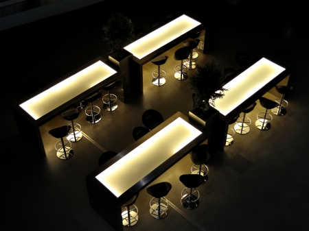 Bar chairs and tables in empty dark barの写真素材