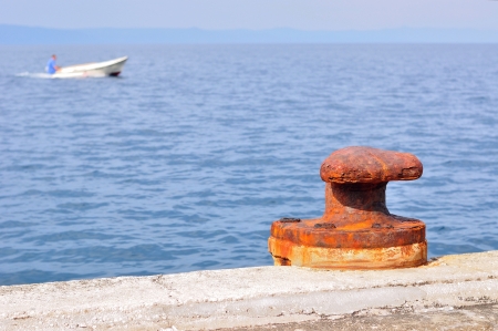 Old, rusty mooring bollard on port of Podgora, Croatiaの写真素材