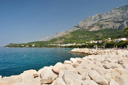 Popular holiday resort Tucepi  Makarska Riviera, Dalmatia, Croatia  Stones in front, mountain Biokovo in background の写真素材