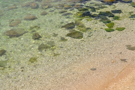 Beach with stones and crystal clear water  Horizontal photoの写真素材