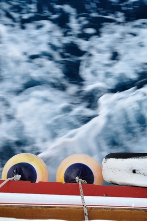 Buoy on body of moving ship  Waving adriatic sea in top part of image  Vertical imageの写真素材
