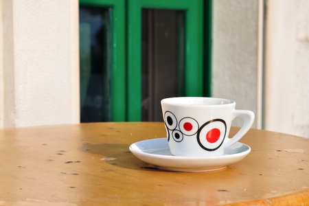 White coffee cup on a brown wooden tableの写真素材
