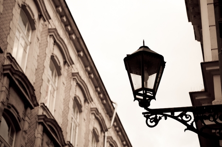 Vintage street lamp on wall of the building. Photo with sepia effectの写真素材