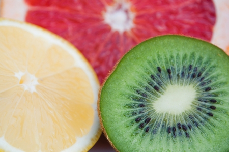 Fresh colorful tropical fruits - lemon, kiwi, red grapefruitの写真素材