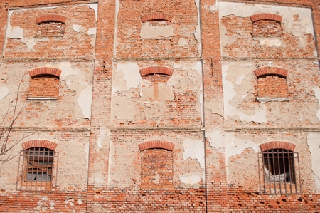 Brick wall of old building with windowsの写真素材