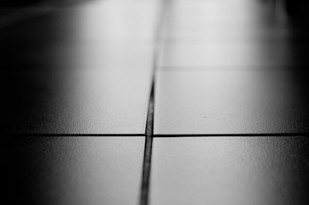 Tiles on the floor with backlight. Black and white photoの写真素材