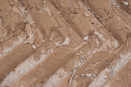 Tractor wheel tracks on the ground as backgroundの写真素材
