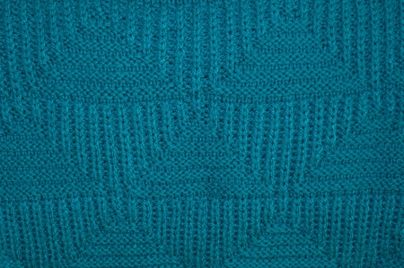 Background texture of knitted blue pullover