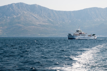 SUCURAJ, CROATIA - 18 JULY 2013: Ferry of company Jadrolinija near the island Hvar in Croatia. Mountain Biokovo in background.のeditorial素材