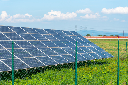 Solar panels in the field with blue sky. Photovoltaic modules produces green, environmentally friendly, renewable energy from the sun.の写真素材