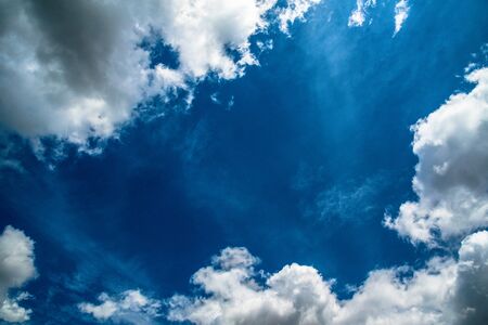 Blue sky background with white clouds. Space in centerの写真素材