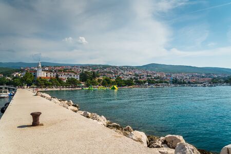 The quay of Crikvenica with stones under blue sky. Crikvenica is a popular holiday resort in Kvarner riviera in Croatiaの写真素材