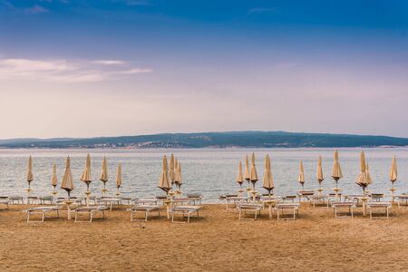 Sunshades on the empty beach of Crikvenica in the early morning. Crikvenica is a popular holiday resort in Croatiaの写真素材