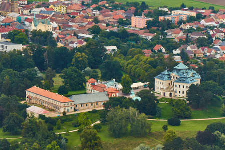 Chlumec nad Cidlinou, Czechia - 08/25/2019: Aerial photo of baroque castle Karlova Koruna surrounded by parks and trees and city in the backgroundのeditorial素材