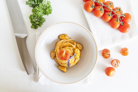 Italian spaghetti with tomato sauce and cherry tomatoesの写真素材