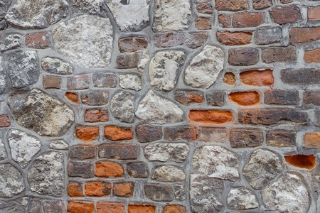 Grungy old red brick and gray stone wall background. Vintage backgroundの写真素材