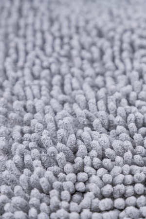 Light gray carpet texture. Doormat carpet closeup. Pattern, details. Gray backgroundの写真素材