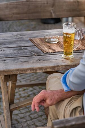 Weimar, Germany, September 16. Mens hands and German beer. Rustic styleのeditorial素材
