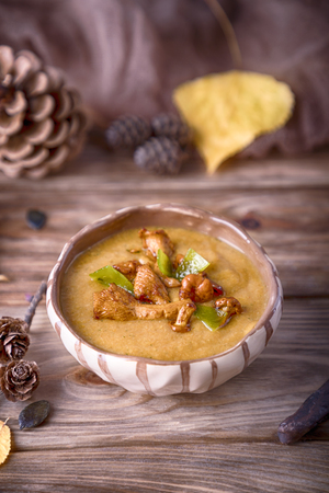 Homemade pumpkin soup with chanterelle mushrooms. Autumn menuの写真素材