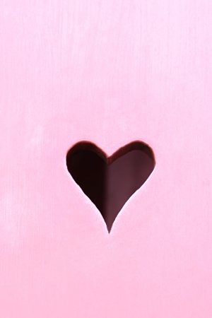 Wooden pink shutter with a hearts. Details. Copy space
